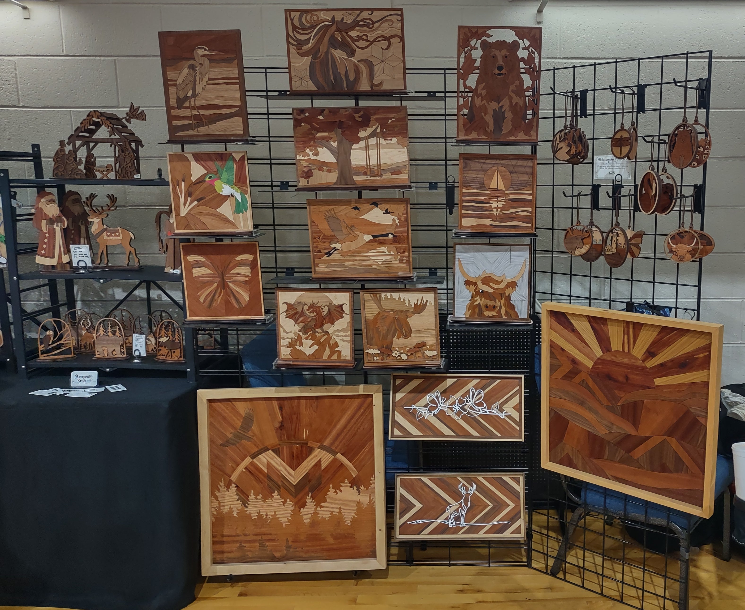 Artspeak Studio display of signature wood marquetry artwork on display at an event.